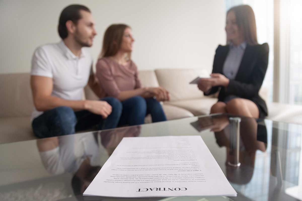 couple and advisor with contract - blurred